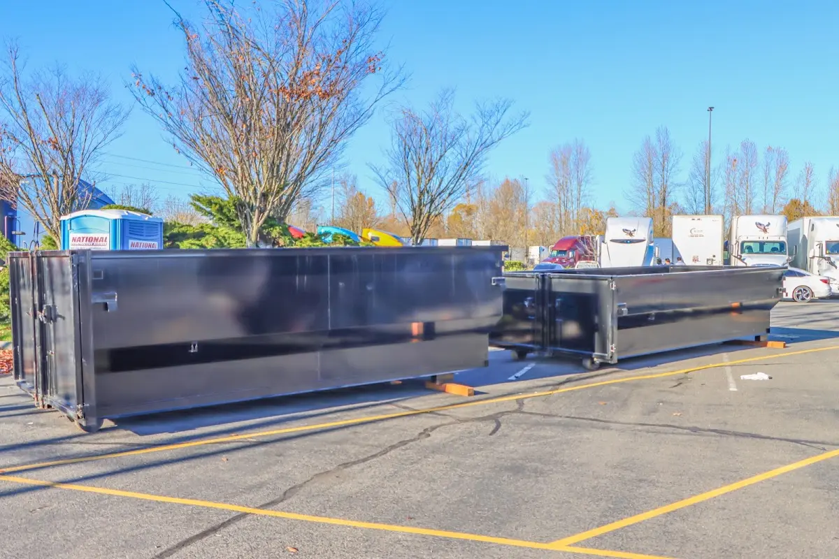 Professional dumpster rental service with roll-off container on residential driveway in St. Cloud
